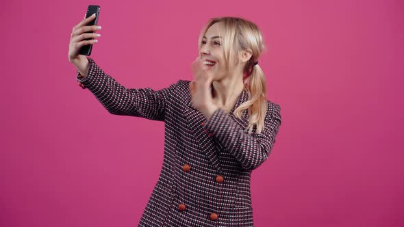 Excited and Happy Young Woman She Holds the Phone in Her Hand and Talks Online with Loved Ones