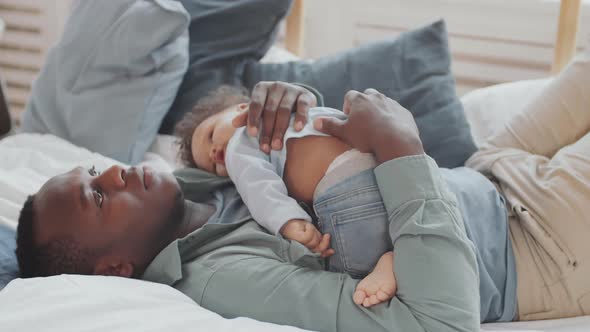 Dad Lulling Baby to Sleep