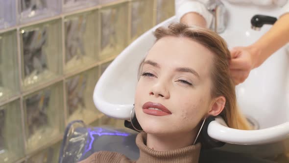 Young Woman Dyeing Hair in Beauty Saloon