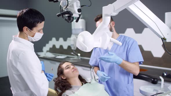 Dental Assistant and Dentist Examining Female Patient