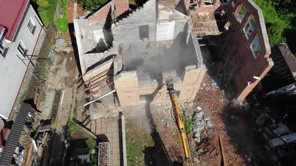 Excavator Breaks Wall of Abandoned Cottage at Village Block