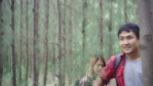 Hiker Asia backpacker couple on hiking adventure feeling freedom walk in forest their holidays.