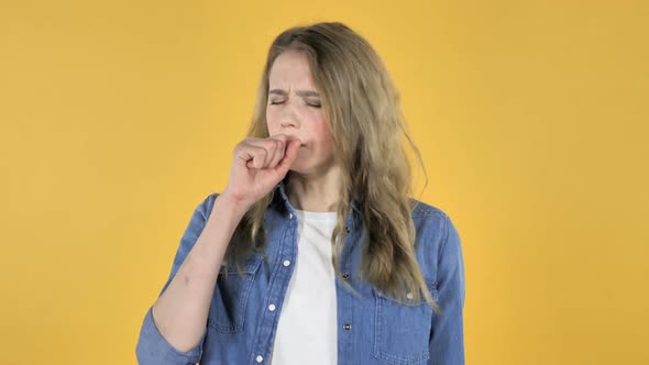 Sick Young Pretty Girl Coughing on Yellow Background