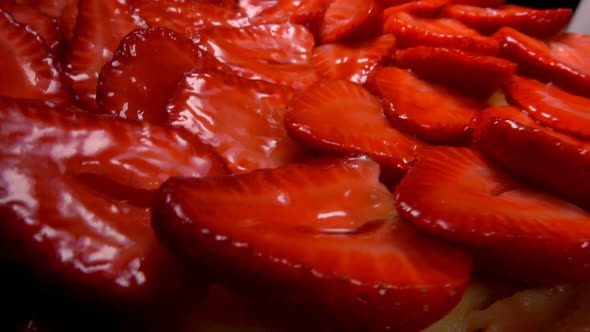 Close-up of a Strawberry Pie with Delicious Slices Placed on the Table