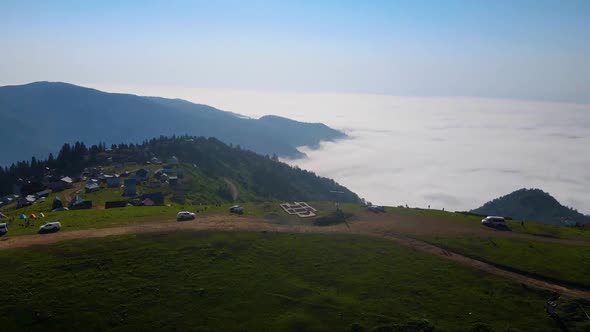 Drone Flight Over the Mountains and Thick White Clouds