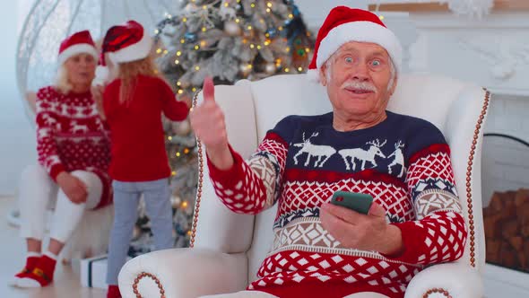 Senior Old Grandfather Man Buy Christmas Gift Presents Doing Online Shopping on Mobile Phone at Home