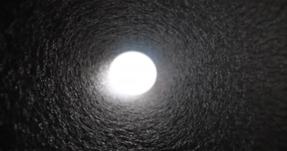 Bright White Light at End of Gray Pipe Closeup