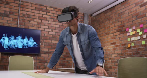 Creative businessman using virtual reality headset in modern office