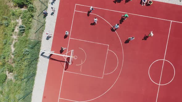Aerial View of Teenagers Playing Basketball on the Summer Basketball Court