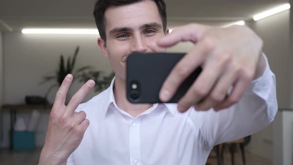 Businessman Taking Selfie with Smart phone in Office