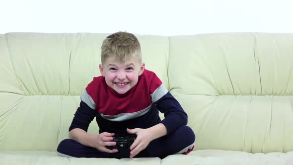 Teen with Games Console Playing Game on Sofa, Slow Motion alt