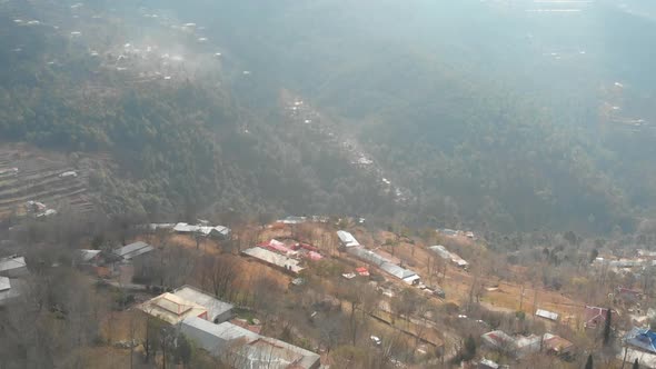 Aerial View Of Misty Hillside Landscape Of Muzaffarabad In Pakistan. Slow Dolly Forward