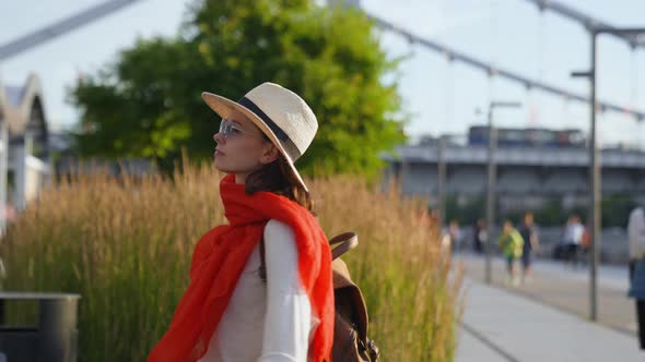 Happy tourist with a red scarf outdoors in a summer city