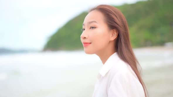 Asian woman enjoy around beautiful beach sea ocean