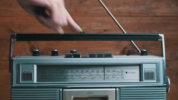 Girl's Hand Twists and Presses the Buttons on the Retro Radio Tape Recorder