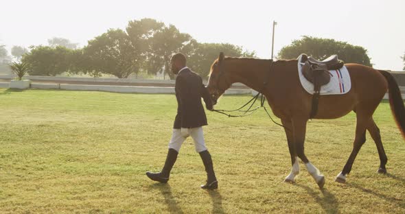 African American man walking with his dressage horse
