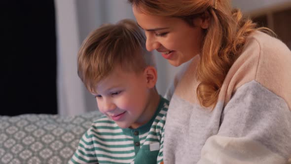 Mother and Son Using Tablet Computer at Home