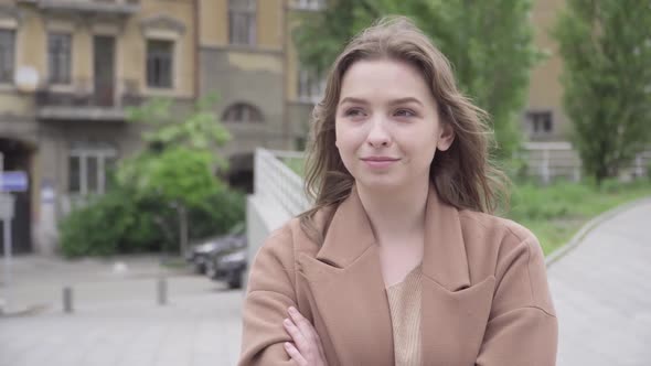 Close-up of Excited Beautiful Woman Hugging Boyfriend Coming for Date. Portrait of Charming Young