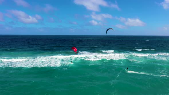 Two kite surfers in the Atlantic Ocean on a beautiful day.
