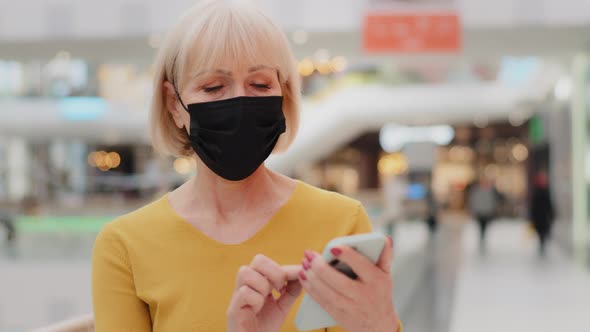 Mature Caucasian Woman in Protective Mask Walking Indoors Focused Serious Middleaged Businesswoman