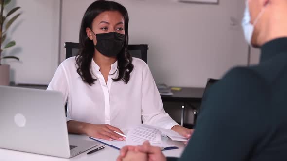 People with Medical Mask Communicate at Table in Office with Spbi Document