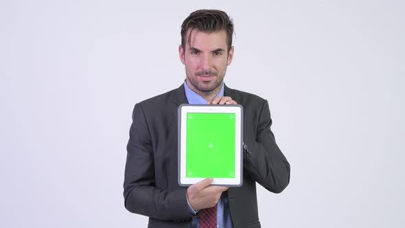 Young Happy Hispanic Businessman Showing Digital Tablet