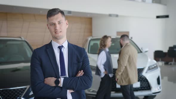 Portrait of a Sales Manager for New Cars in the Salon of an Official Dealer