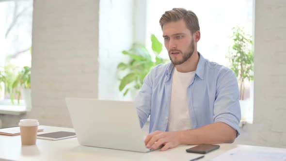 Young Creative Man with Laptop Having Loss Failure