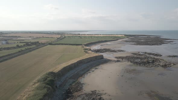 Rugged Coastal Landscape In The Town Of Balbriggan In Ireland On A Hot Summer Day. aerial pullback