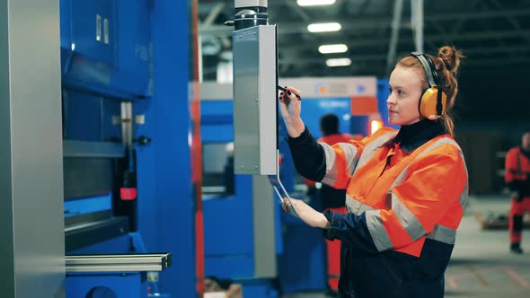 Lady Worker Is Navigating Screen Factory Mechanism