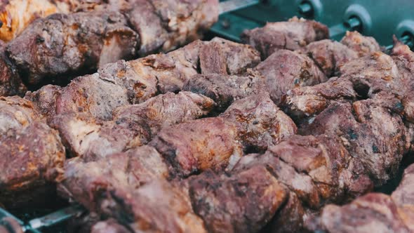 Shish Kebab on Skewers Is Cooked on the Automatic Grill at Street Food Festival.