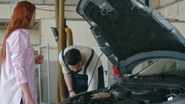 Mechanic Filling Windshield Washer Fluid alt