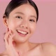 Slow motion Beauty shot of Beautiful Asian girl looking at camera isolated on pink background - VideoHive Item for Sale