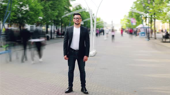 Time Lapse of Handsome Businessman Standing Outdoors in Pedestrian Street