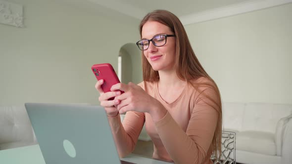 Portrait of Young Woman Freelancer Reading Notification on Smartphone