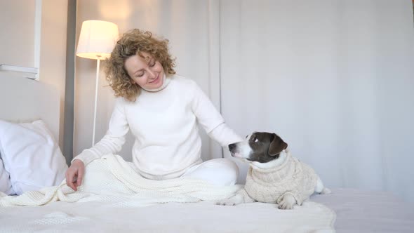 Woman And Her Dog Relaxing In The Morning In Bed