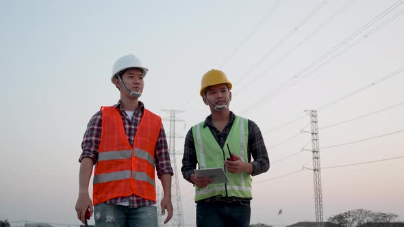 The construction of a power line was observed by two Electrical engineers. alt