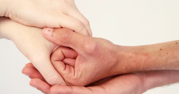 Close-up of couple holding hands