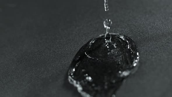 Super Slow Motion Shot of Water Splashing on Waterproof Cloth at 1000Fps