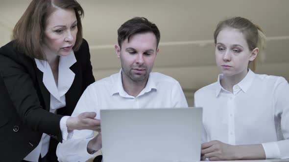 Angry Businesswoman Talking with Employees