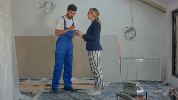 Construction Manager and Engineer Working Using Tablet on Building Site