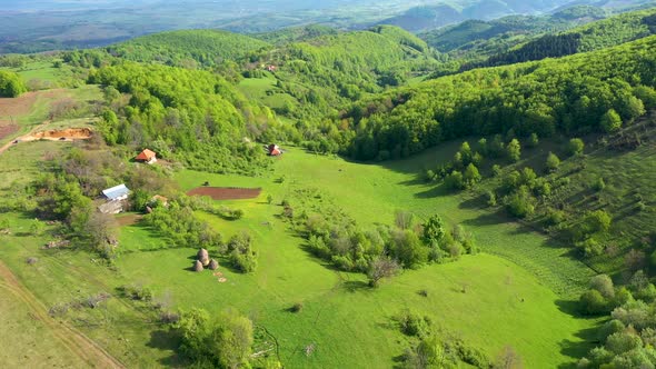 Flying Above Green Countryside Hills