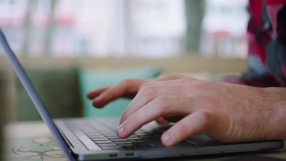 Closeup Details of a Typing Man on His Laptop