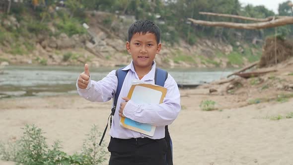 Boy Holding Book And Showing Thump Up