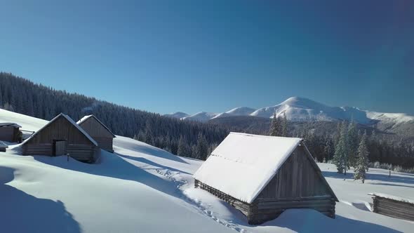 Flying Over the Mountains and Shepherd Houses in Winter