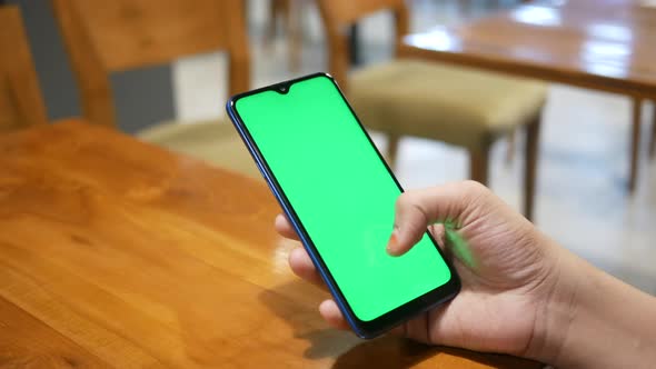 Close Up of Young Women Hand Using Smart Phone with Green Screen at Cafe