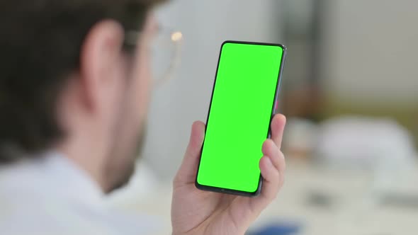 Rear View of Young Man Watching Smartphone Chroma Screen