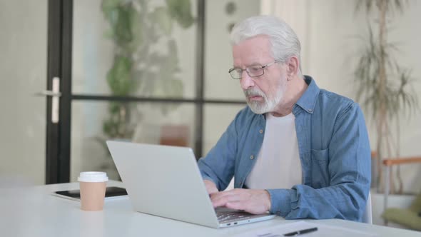 Senior Old Man Working on Laptop in Office