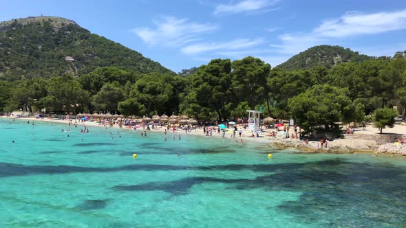 Boat in the sea, beach, people, and a nice sunny and hot summer day