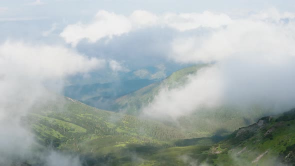 Timelaps Shot with Fast Moving Clouds in a Beautiful Green Valley of the Mountains in Spring